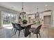 Sunlit dining room with large table, access to patio, and hardwood floors at 1679 Eastside Parc St, Atlanta, GA 30316
