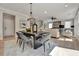 Open concept dining room features a dark wood table and gray velvet chairs at 1679 Eastside Parc St, Atlanta, GA 30316