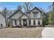 Two-story farmhouse with a welcoming porch and well-manicured lawn at 1679 Eastside Parc St, Atlanta, GA 30316