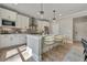 Eat-in kitchen with white cabinets, quartz countertops and island with seating at 1679 Eastside Parc St, Atlanta, GA 30316