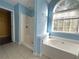 Bathroom with shower, tub, and large window at 166 Greentree Trl, Temple, GA 30179