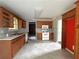 Kitchen with wood cabinets, white appliances, and tile floors at 166 Greentree Trl, Temple, GA 30179