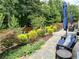 Stone patio with seating area and lush landscaping at 3909 Makeover Ct, Atlanta, GA 30349