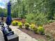 Landscaped backyard with stone pathway and privacy fence at 3909 Makeover Ct, Atlanta, GA 30349