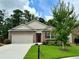Brick home with 2-car garage, landscaping, and a welcoming front yard at 3909 Makeover Ct, Atlanta, GA 30349