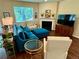 Cozy living room featuring fireplace, hardwood floors, and ample natural light at 3909 Makeover Ct, Atlanta, GA 30349