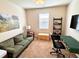 Home office featuring a sofa, desk, and ample natural light at 3909 Makeover Ct, Atlanta, GA 30349