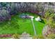 Expansive aerial view showcases lush green lawn and a charming home with additional outbuilding at 239 Cedar Ridge Dr, Dallas, GA 30157
