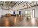 Spacious finished basement with wood floors, painted brick, and dining area at 239 Cedar Ridge Dr, Dallas, GA 30157