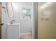 Cozy bathroom with a white vanity, oval mirror, natural lighting, and a walk-in shower at 239 Cedar Ridge Dr, Dallas, GA 30157