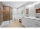 Bathroom featuring a glass shower with tile surround, double sinks, and bench at 239 Cedar Ridge Dr, Dallas, GA 30157