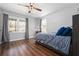 Bright bedroom with wood floors, three windows, and a ceiling fan at 239 Cedar Ridge Dr, Dallas, GA 30157