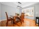 Sunlit dining room featuring hardwood floors, modern light fixture, and a large window for natural light at 239 Cedar Ridge Dr, Dallas, GA 30157