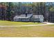 Charming ranch-style home with a welcoming porch and beautiful, expansive front lawn at 239 Cedar Ridge Dr, Dallas, GA 30157