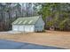 Three-car garage features a green metal roof, vinyl siding, and a private entrance, all on a spacious lot at 239 Cedar Ridge Dr, Dallas, GA 30157
