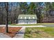 Three-car garage features a green metal roof, vinyl siding, a private entrance, and a basketball hoop at 239 Cedar Ridge Dr, Dallas, GA 30157