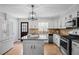Well-lit kitchen features stainless steel appliances, a center island, and white cabinetry at 239 Cedar Ridge Dr, Dallas, GA 30157