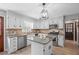 Modern kitchen features stainless steel appliances, center island, and stylish tile backsplash at 239 Cedar Ridge Dr, Dallas, GA 30157