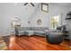 Bright living room with vaulted ceiling, wood floors, and comfortable, stylish sectional sofa at 239 Cedar Ridge Dr, Dallas, GA 30157