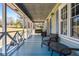 Relaxing covered porch with cozy seating, perfect for enjoying the serene outdoor view at 239 Cedar Ridge Dr, Dallas, GA 30157