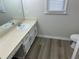 Bright bathroom with updated vanity, new flooring, and toilet at 6146 Douglas Manor Ct, Douglasville, GA 30134