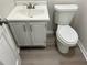 Small bathroom with white toilet and sink at 6146 Douglas Manor Ct, Douglasville, GA 30134
