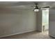 Carpeted bedroom with ceiling fan and access to bathroom at 6146 Douglas Manor Ct, Douglasville, GA 30134