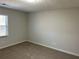 Bright bedroom with neutral walls and carpet at 6146 Douglas Manor Ct, Douglasville, GA 30134