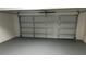 Attached garage with gray epoxy flooring at 6146 Douglas Manor Ct, Douglasville, GA 30134
