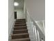 Staircase with carpeted steps and white railing at 6146 Douglas Manor Ct, Douglasville, GA 30134