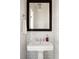 Small bathroom with white subway tile, pedestal sink, and dark framed mirror at 9057 Selborne Ln, Chattahoochee Hills, GA 30268