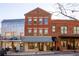 Brick building with a metal roof and storefront at 9057 Selborne Ln, Chattahoochee Hills, GA 30268