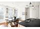 Open kitchen with island and farmhouse style table at 9057 Selborne Ln, Chattahoochee Hills, GA 30268