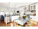 Open concept kitchen with island and dining area at 9057 Selborne Ln, Chattahoochee Hills, GA 30268