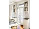 Bright kitchen features white cabinetry, granite countertops and French doors leading to a balcony at 9057 Selborne Ln, Chattahoochee Hills, GA 30268