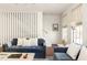 Living room with blue couches and white accents at 9057 Selborne Ln, Chattahoochee Hills, GA 30268