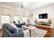 Spacious living room with hardwood floors and comfortable seating at 9057 Selborne Ln, Chattahoochee Hills, GA 30268