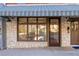 Commercial storefront featuring a striped awning and large windows at 9057 Selborne Ln, Chattahoochee Hills, GA 30268