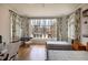 Bright bedroom with hardwood flooring, twin beds, a large window, and decorative patterned curtains and decor at 133 Blackland Nw Rd, Atlanta, GA 30342