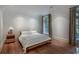 Serene bedroom with hardwood floors, neutral decor, and natural light from the window at 133 Blackland Nw Rd, Atlanta, GA 30342