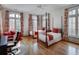 Spacious bedroom with hardwood floors, large windows, red accents, and stylish patterned curtains, inviting relaxation at 133 Blackland Nw Rd, Atlanta, GA 30342