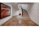 Elegant entryway with curved staircase, modern art, and unique concrete flooring at 133 Blackland Nw Rd, Atlanta, GA 30342