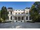 Stunning two-story luxury home boasts a columned porch and manicured landscaping, offering timeless elegance and curb appeal at 133 Blackland Nw Rd, Atlanta, GA 30342