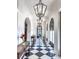Elegant home featuring a grand hallway with high ceilings, checkered tile floor, arched doorways and ornate lighting at 133 Blackland Nw Rd, Atlanta, GA 30342
