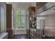 Kitchen with custom wood cabinetry, a stainless steel refrigerator, and a window with a backyard view at 133 Blackland Nw Rd, Atlanta, GA 30342