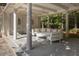 Outdoor living space features an abundance of seating on a large stone patio and classic columns at 133 Blackland Nw Rd, Atlanta, GA 30342