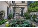 Outdoor patio with garden, stone water feature, and bedroom view with glass doors for a seamless indoor-outdoor living at 133 Blackland Nw Rd, Atlanta, GA 30342