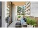 Private balcony with seating, plants, and treetop views at 2575 Peachtree Ne Rd # 9G, Atlanta, GA 30305