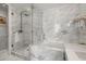 Modern bathroom with marble walls and a glass shower enclosure at 2575 Peachtree Ne Rd # 9G, Atlanta, GA 30305