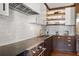 Modern kitchen with white tile backsplash and dark wood cabinets at 2575 Peachtree Ne Rd # 9G, Atlanta, GA 30305